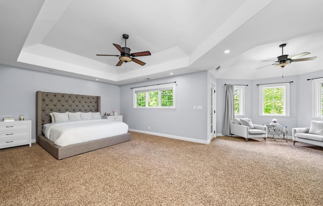 carpeted bedroom featuring a tray ceiling, baseboards, ceiling fan, and recessed lighting