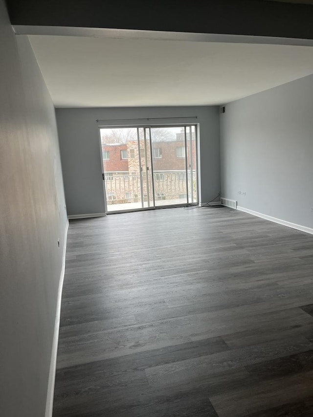 3237 S Manor Dr Unit 310, Lansing, IL 60438 - unfurnished room featuring dark wood-style floors and baseboards