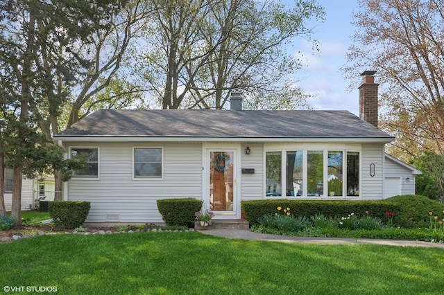 ranch-style home featuring a front yard and a chimney