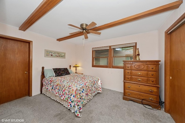 bedroom with carpet floors, beamed ceiling, a ceiling fan, and a closet