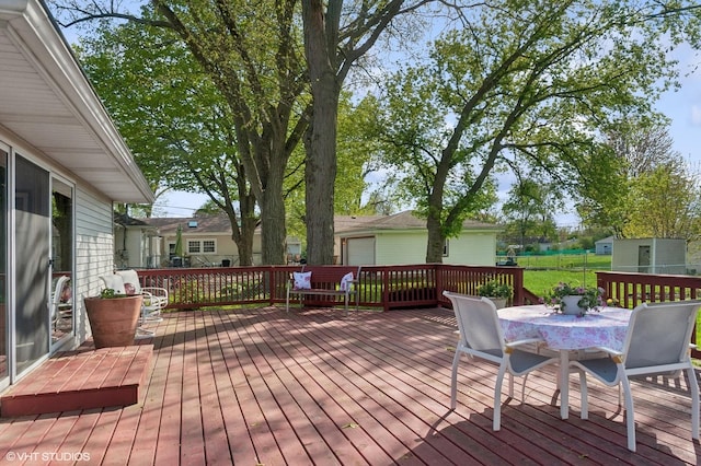 wooden deck featuring outdoor dining area
