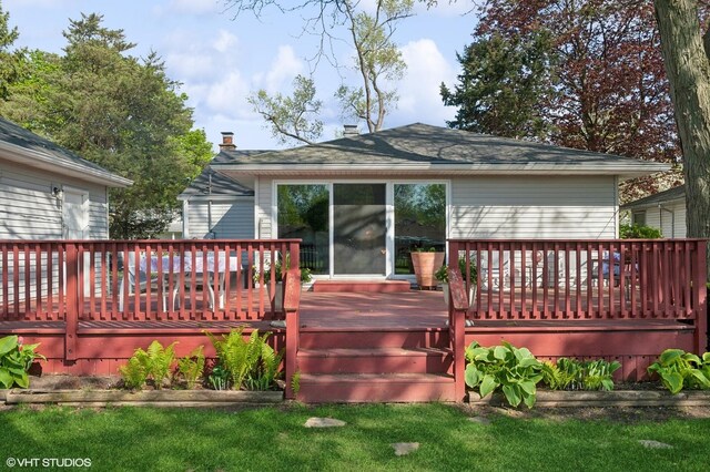 rear view of house featuring a wooden deck
