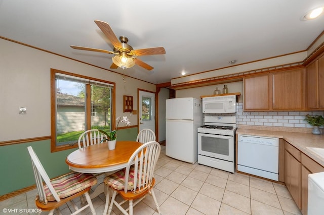 kitchen with white appliances, light countertops, tasteful backsplash, light tile patterned flooring, and a ceiling fan