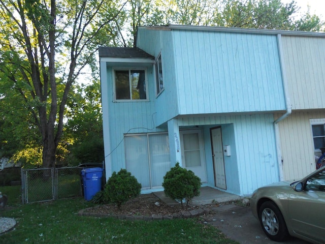 view of property featuring fence and a gate