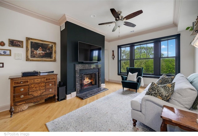 1018 Main St Unit 3, Evanston, IL 60202 - living room featuring light wood-type flooring, a fireplace, a ceiling fan, crown molding, and baseboards