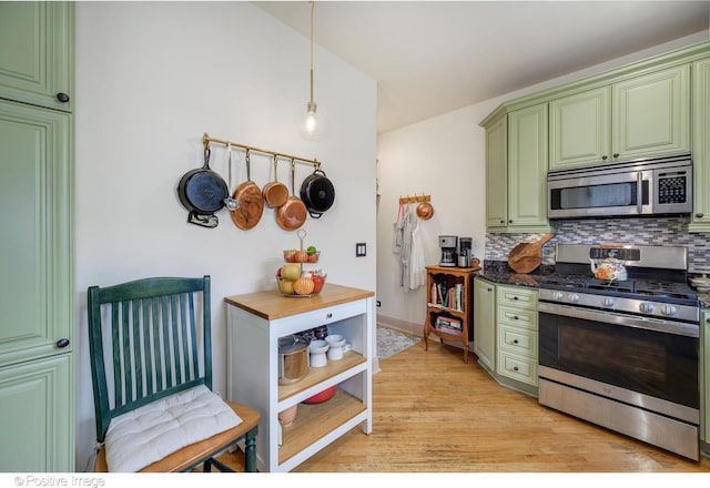 1018 Main St Unit 3, Evanston, IL 60202 - kitchen featuring stainless steel appliances, green cabinets, decorative backsplash, and light wood-style floors