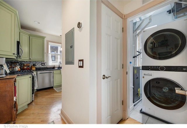 1018 Main St Unit 3, Evanston, IL 60202 - clothes washing area featuring stacked washing machine and dryer, electric panel, and light wood-type flooring
