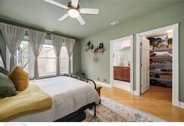 1018 Main St Unit 3, Evanston, IL 60202 - bedroom featuring a spacious closet, light wood-style floors, a closet, baseboards, and ensuite bath