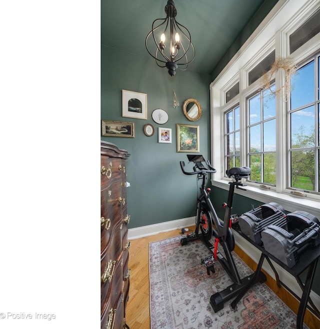 1018 Main St Unit 3, Evanston, IL 60202 - workout area with a chandelier, baseboards, and wood finished floors