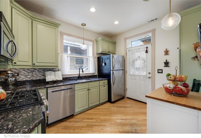 1018 Main St Unit 3, Evanston, IL 60202 - kitchen featuring stainless steel appliances, light wood-type flooring, a sink, green cabinets, and recessed lighting