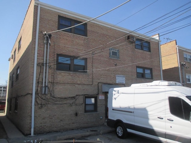 view of side of home with brick siding