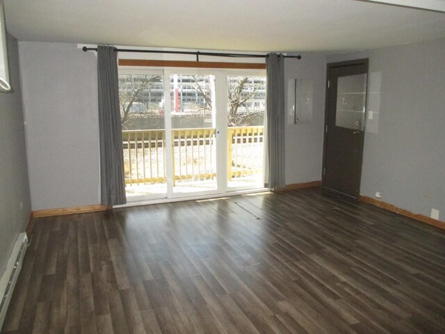 unfurnished room featuring wood finished floors and baseboards