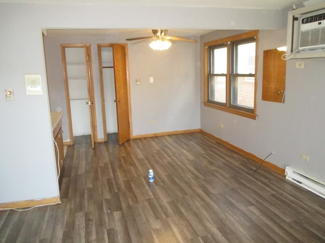 unfurnished room featuring wood finished floors, a wall mounted AC, ceiling fan, baseboards, and baseboard heating