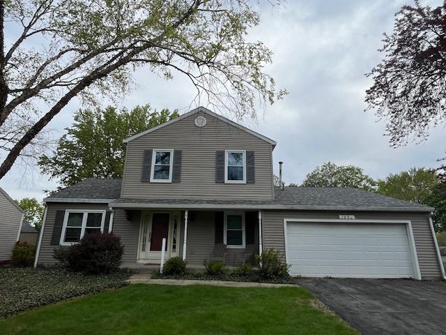 1969 Stanford Dr, Naperville, IL 60565 - traditional-style home featuring driveway, an attached garage, covered porch, and a front lawn