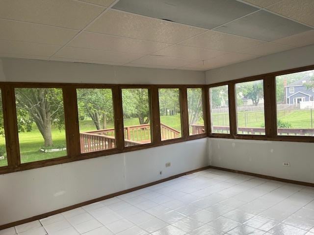 1969 Stanford Dr, Naperville, IL 60565 - unfurnished sunroom featuring a paneled ceiling, plenty of natural light, baseboards, and tile patterned floors