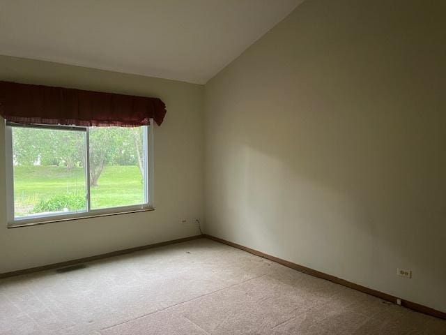 1969 Stanford Dr, Naperville, IL 60565 - unfurnished room featuring light colored carpet, vaulted ceiling, and baseboards