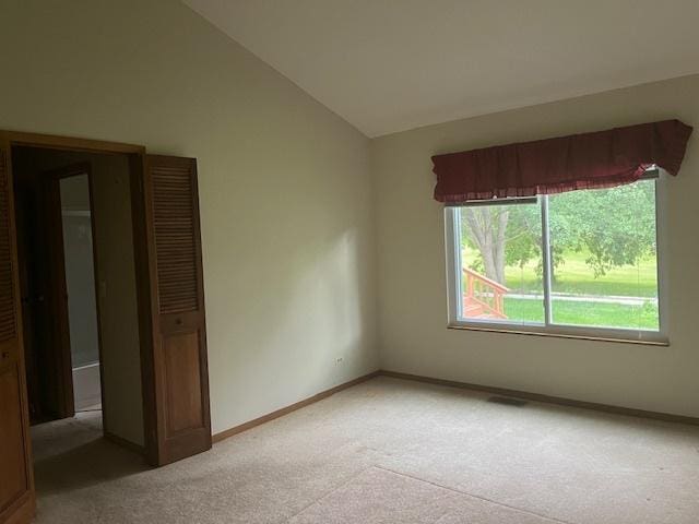 1969 Stanford Dr, Naperville, IL 60565 - spare room with light colored carpet, vaulted ceiling, and baseboards