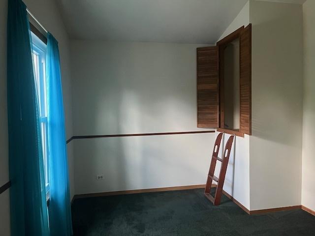1969 Stanford Dr, Naperville, IL 60565 - carpeted empty room with lofted ceiling and baseboards