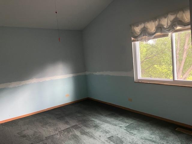 1969 Stanford Dr, Naperville, IL 60565 - carpeted empty room featuring lofted ceiling and baseboards
