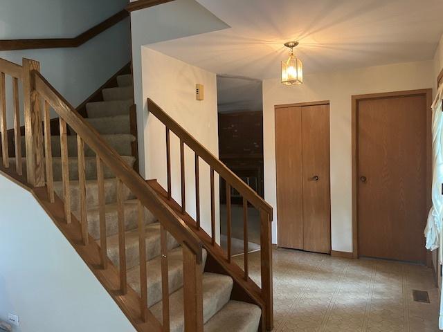 1969 Stanford Dr, Naperville, IL 60565 - staircase featuring a chandelier