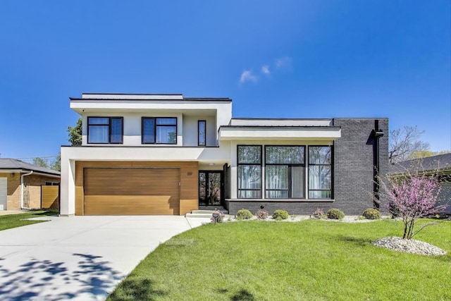 359 E Church St, Elmhurst, IL 60126 - modern home featuring stucco siding, driveway, an attached garage, and a front lawn