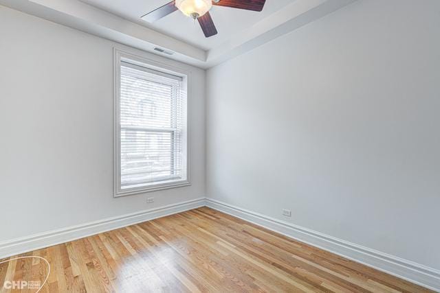 empty room with baseboards, light wood-style flooring, and a ceiling fan
