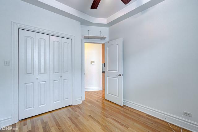 unfurnished bedroom with a closet, light wood-style floors, baseboards, and a ceiling fan