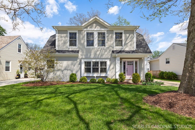 view of front of house featuring a front lawn and concrete driveway