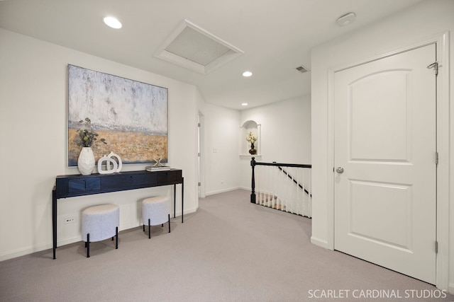sitting room with carpet, an upstairs landing, recessed lighting, attic access, and baseboards