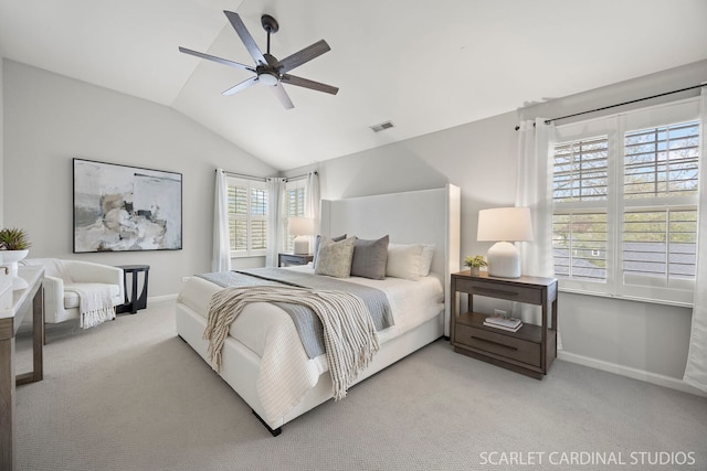 bedroom with lofted ceiling, light colored carpet, baseboards, and ceiling fan