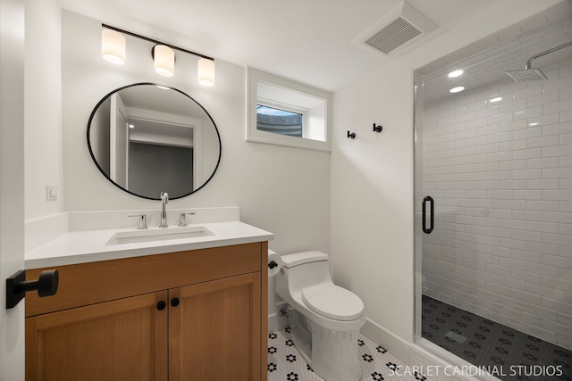 bathroom featuring a shower stall, toilet, and vanity