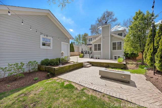 back of property with a patio area, a garage, and a chimney