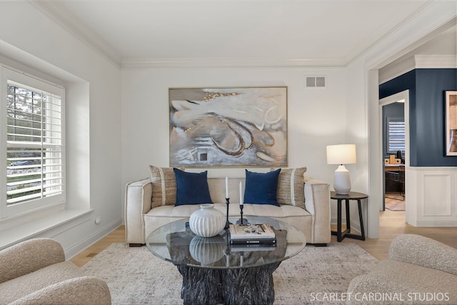 living room featuring ornamental molding and wood finished floors