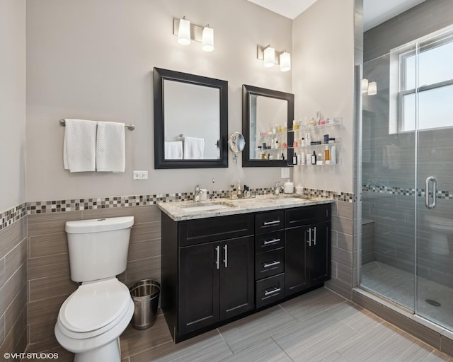 1319 N Oakley Blvd, Chicago, IL 60622 - full bath featuring tile walls, a stall shower, toilet, double vanity, and a wainscoted wall