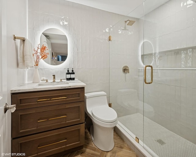 1319 N Oakley Blvd, Chicago, IL 60622 - bathroom featuring tile walls, a shower stall, vanity, toilet, and wood finished floors