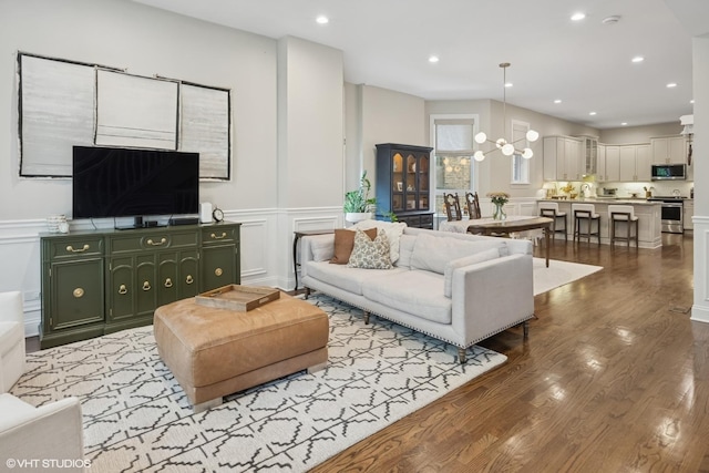 1319 N Oakley Blvd, Chicago, IL 60622 - living area with a decorative wall, wood finished floors, a wainscoted wall, a chandelier, and recessed lighting