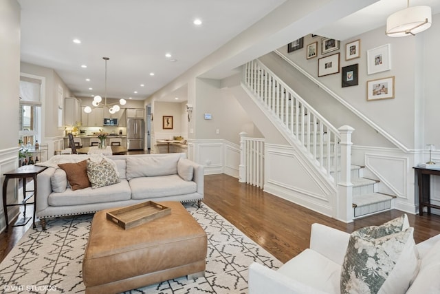 1319 N Oakley Blvd, Chicago, IL 60622 - living room featuring a decorative wall, wood finished floors, wainscoting, recessed lighting, and stairway