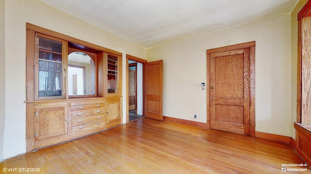 3072 N Haussen Ct, Chicago, IL 60618 - unfurnished bedroom with light wood-style floors and baseboards
