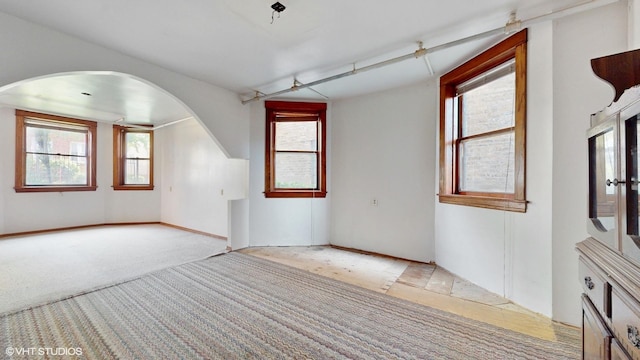3072 N Haussen Ct, Chicago, IL 60618 - spare room with arched walkways, plenty of natural light, and light carpet