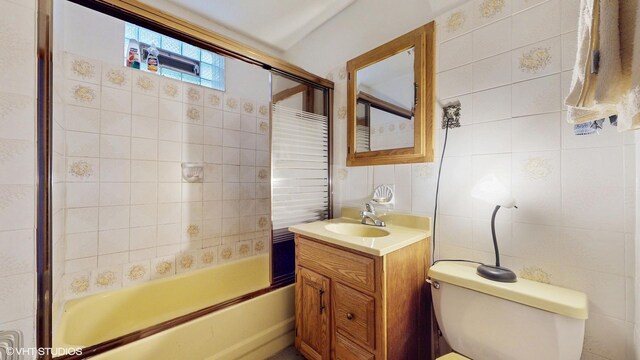3072 N Haussen Ct, Chicago, IL 60618 - bathroom with shower / bath combination with glass door, vanity, tile walls, and toilet