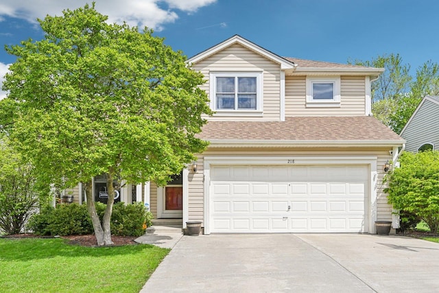 view of front of property with an attached garage, driveway, a shingled roof, and a front yard