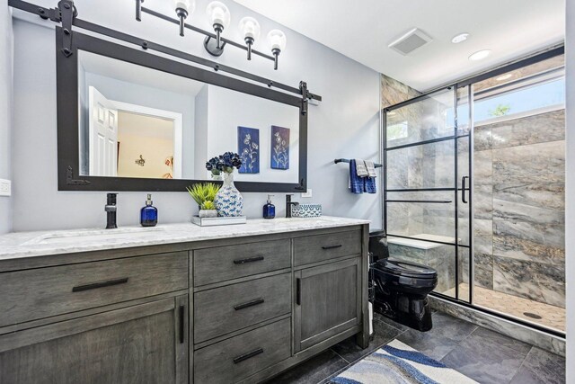 bathroom with a shower stall, toilet, and double vanity