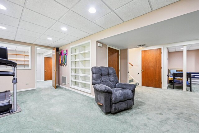 sitting room with carpet flooring, recessed lighting, stairs, baseboards, and a paneled ceiling