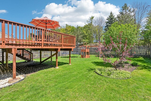 view of yard featuring a playground and a deck
