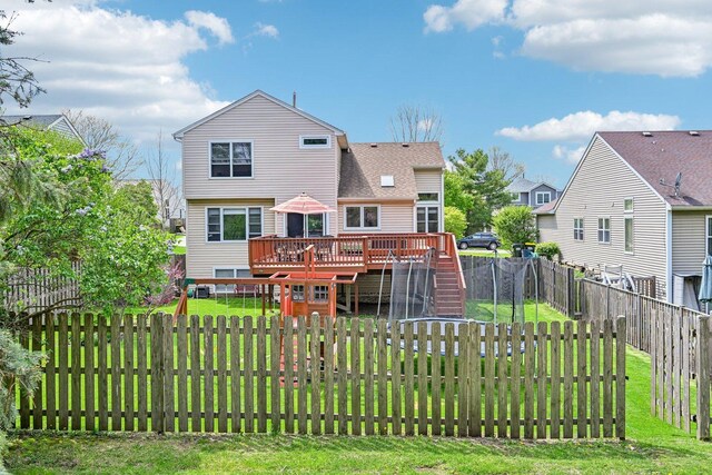 rear view of house featuring a wooden deck and stairway