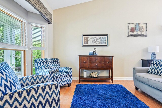 living area with wood finished floors and baseboards