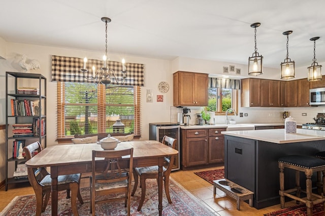 1593 Surridge Ct, Mundelein, IL 60060 - kitchen featuring a sink, a chandelier, stainless steel microwave, light countertops, and backsplash