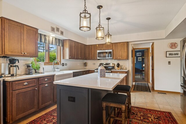 1593 Surridge Ct, Mundelein, IL 60060 - kitchen featuring appliances with stainless steel finishes, a kitchen bar, decorative backsplash, a sink, and light tile patterned floors
