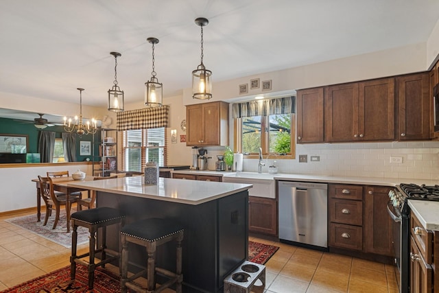 1593 Surridge Ct, Mundelein, IL 60060 - kitchen with appliances with stainless steel finishes, light tile patterned floors, light countertops, and decorative backsplash