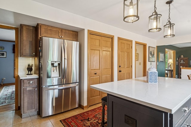 1593 Surridge Ct, Mundelein, IL 60060 - kitchen with stainless steel refrigerator with ice dispenser, baseboards, decorative backsplash, a kitchen island, and light tile patterned floors